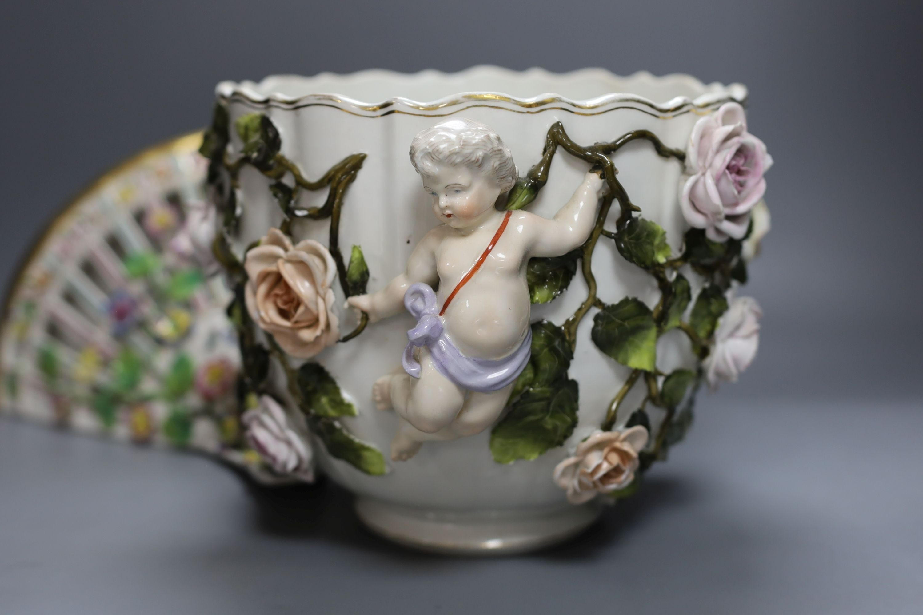 A late 19th century Sitzendorf cherub jardiniere, 18cm tall, and a porcelain floral wall bracket